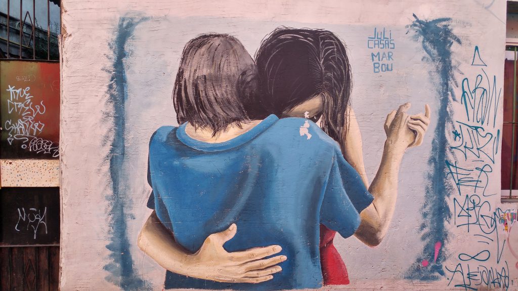 ילדה וילד מתחבקים על קיר בבואנוס איירס